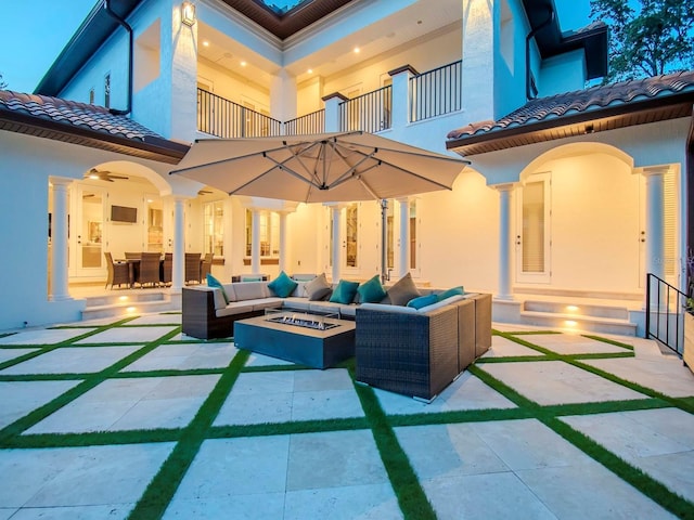 view of patio with an outdoor living space with a fire pit