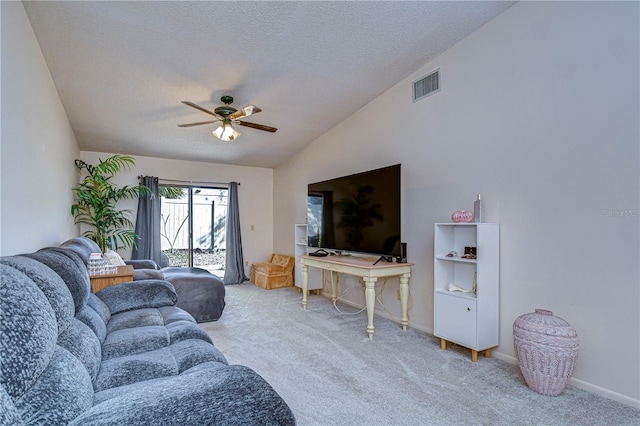 living room with lofted ceiling, light colored carpet, a textured ceiling, and ceiling fan