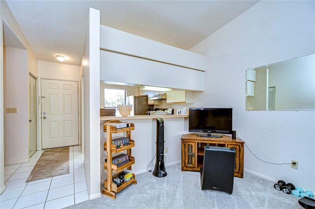 tiled living room with vaulted ceiling and a textured ceiling