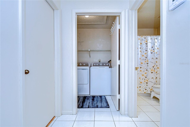 bathroom featuring tile patterned floors and washer and clothes dryer