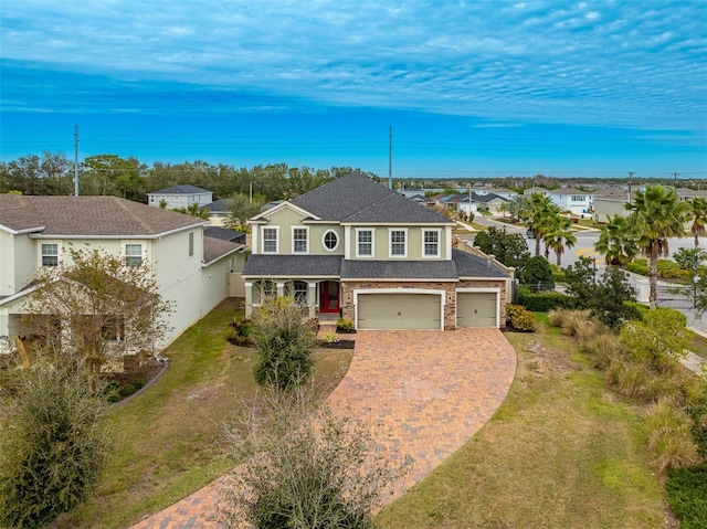 view of front of home featuring a garage and a front yard