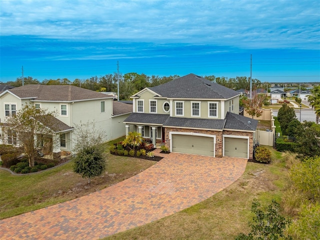 view of front of home with a garage and a front lawn