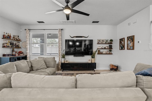 living room with bar and ceiling fan