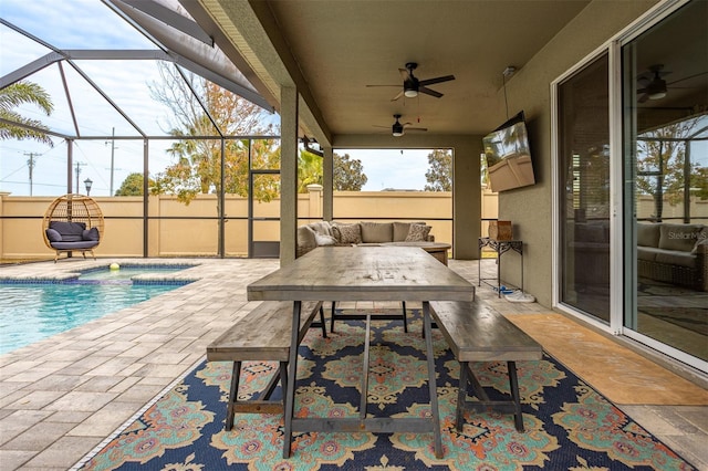 view of patio / terrace with outdoor lounge area, ceiling fan, a lanai, and a fenced in pool