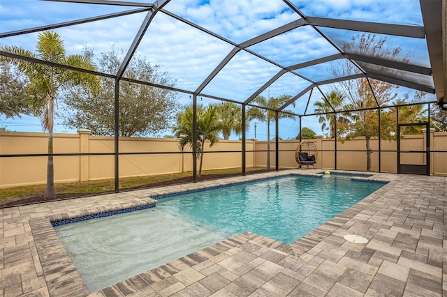 view of pool featuring a patio area and glass enclosure