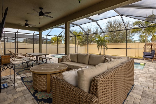 view of patio with a lanai, outdoor lounge area, and ceiling fan