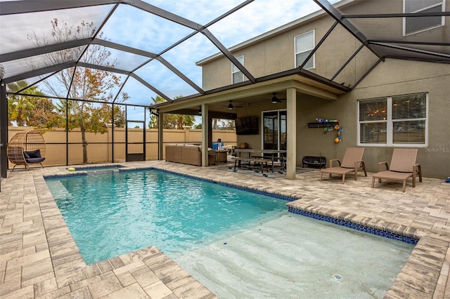 view of pool with a patio, outdoor lounge area, an in ground hot tub, ceiling fan, and glass enclosure