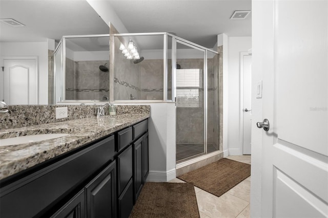 bathroom featuring vanity, an enclosed shower, and tile patterned flooring