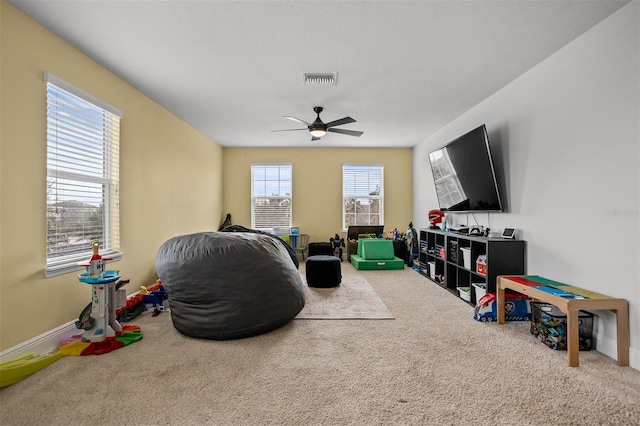 rec room with carpet floors and ceiling fan