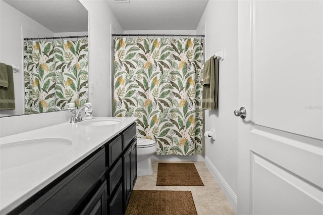 bathroom featuring vanity, toilet, and tile patterned flooring