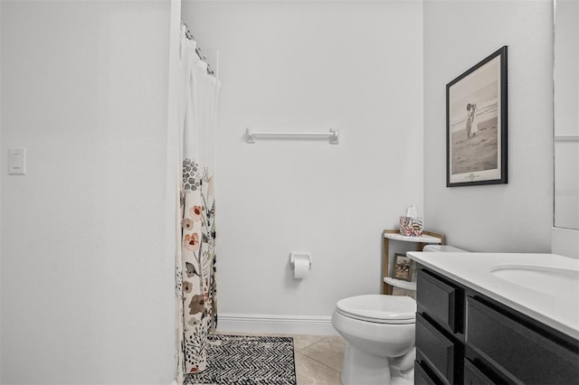 bathroom featuring tile patterned flooring, vanity, and toilet