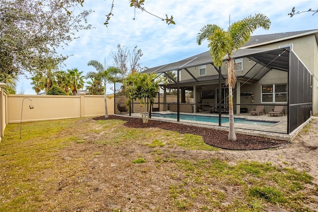 view of yard featuring a fenced in pool, a patio area, and glass enclosure