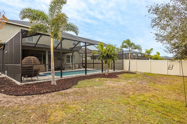 view of yard with a fenced in pool and a lanai