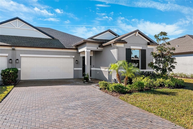 view of front facade with a garage and a front lawn