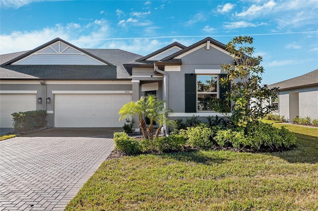 view of front of house with a garage and a front lawn