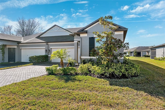 view of front of house featuring a garage and a front yard