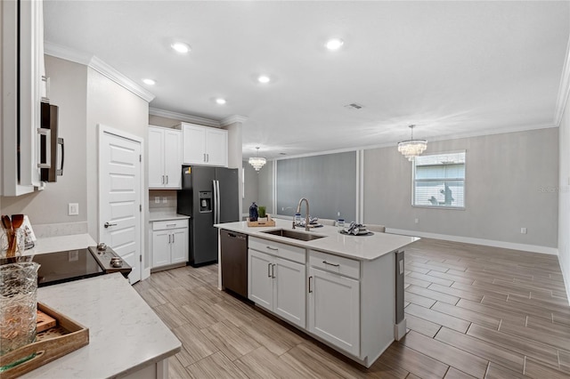 kitchen with white cabinetry, sink, appliances with stainless steel finishes, and a center island with sink