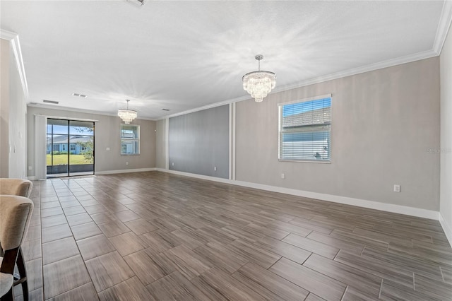 unfurnished living room featuring crown molding, wood-type flooring, and an inviting chandelier