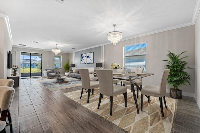 dining space featuring ornamental molding and a notable chandelier