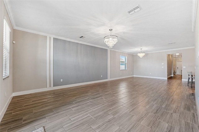 empty room featuring an inviting chandelier and crown molding