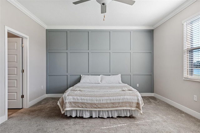 carpeted bedroom featuring crown molding and ceiling fan