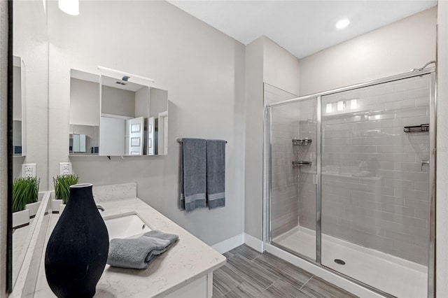 bathroom featuring vanity, a shower with door, and hardwood / wood-style floors