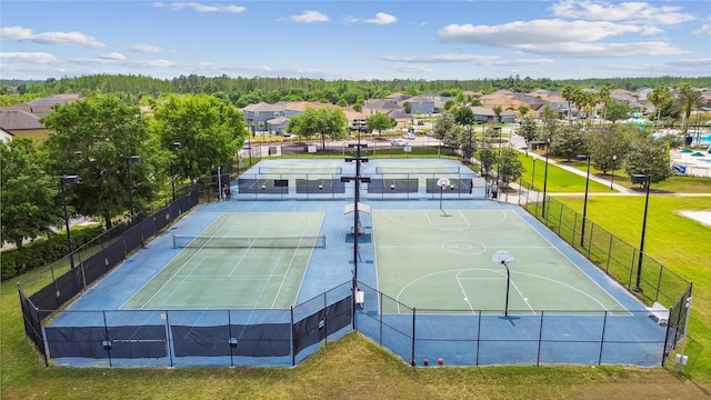 view of sport court featuring a yard and tennis court