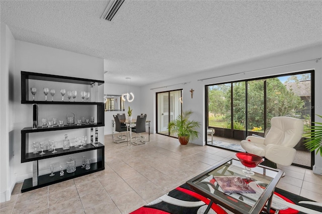 living room featuring light tile patterned floors and a textured ceiling