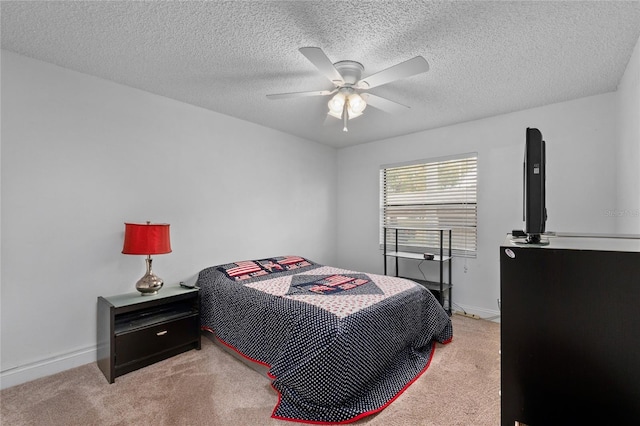 carpeted bedroom featuring a textured ceiling and ceiling fan