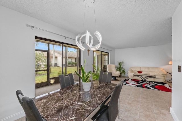 tiled dining space with a textured ceiling