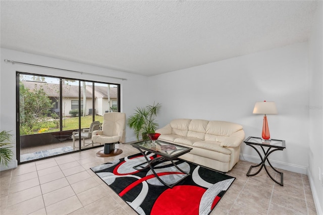 living room featuring light tile patterned floors and a textured ceiling