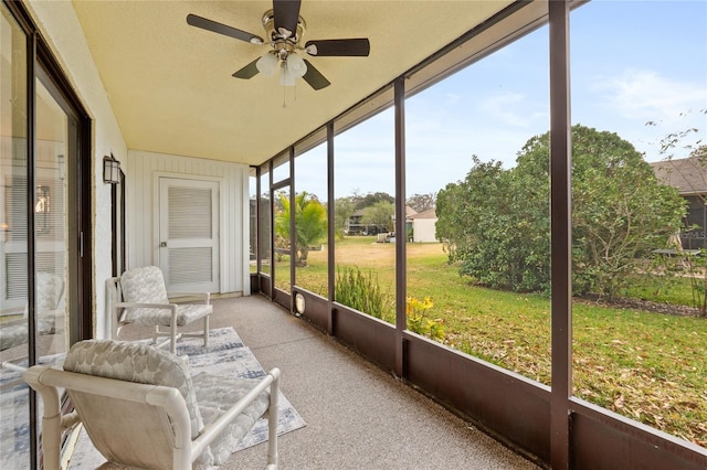 sunroom / solarium featuring ceiling fan