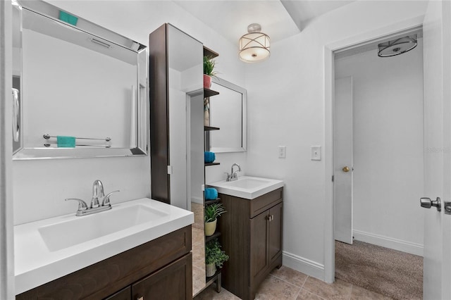 20 Sylvia Pl, Oldsmar, FL 34677 - full bathroom with two vanities, tile patterned flooring, and baseboards
