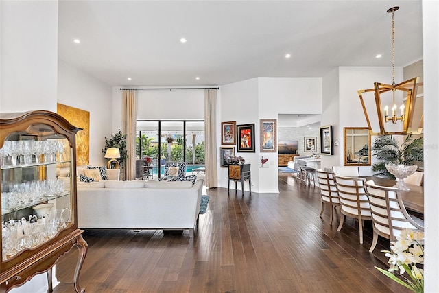 bedroom featuring dark wood-type flooring, access to outside, and a chandelier