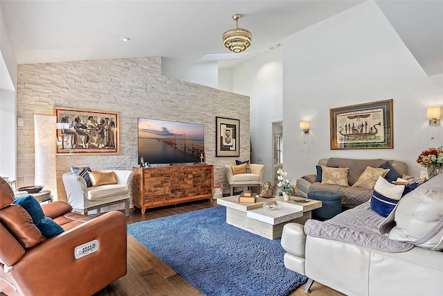 living room with high vaulted ceiling and dark hardwood / wood-style floors