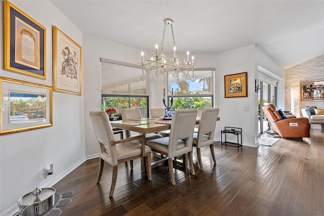 dining room with vaulted ceiling, dark hardwood / wood-style floors, and a chandelier