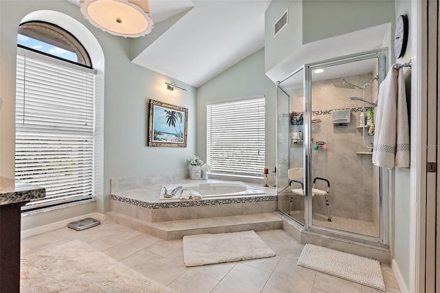 bathroom with independent shower and bath, vaulted ceiling, and tile patterned flooring