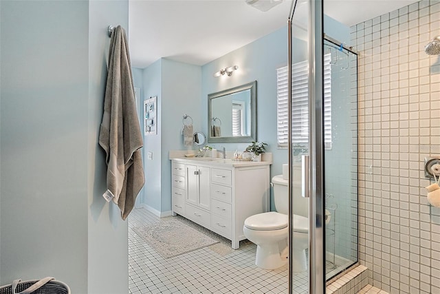 bathroom with vanity, tile patterned floors, a shower with door, and toilet