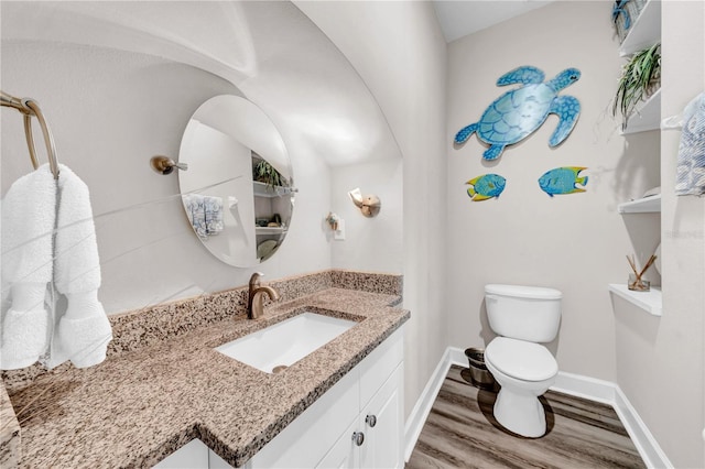 bathroom featuring hardwood / wood-style flooring, vanity, and toilet