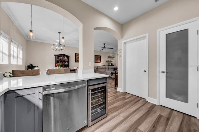 kitchen featuring hardwood / wood-style floors, decorative light fixtures, beverage cooler, stainless steel dishwasher, and ceiling fan