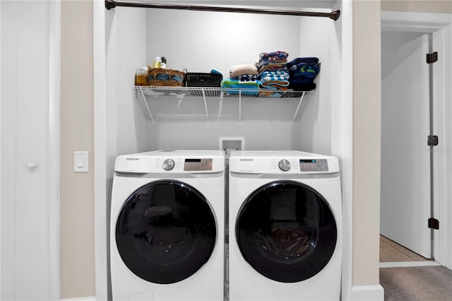 clothes washing area with light tile patterned floors and washing machine and dryer