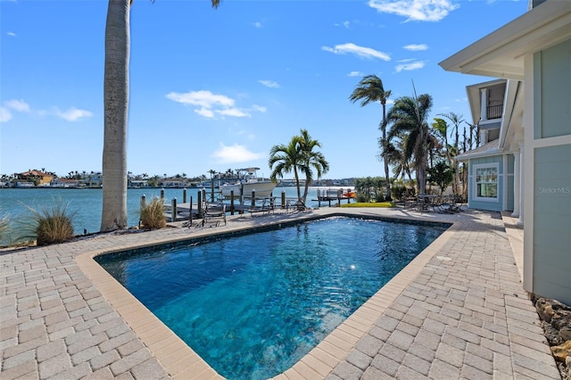 view of pool with a water view and a patio area