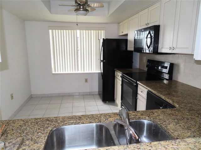 kitchen featuring backsplash, white cabinets, a raised ceiling, and black appliances