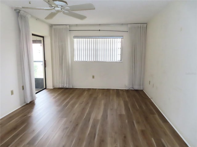 unfurnished room with dark wood-type flooring and ceiling fan