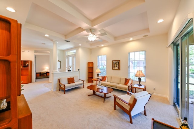 living room featuring coffered ceiling, a wealth of natural light, light colored carpet, and ornate columns