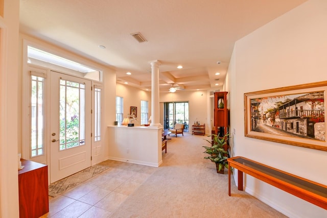 entrance foyer featuring light tile patterned floors and decorative columns