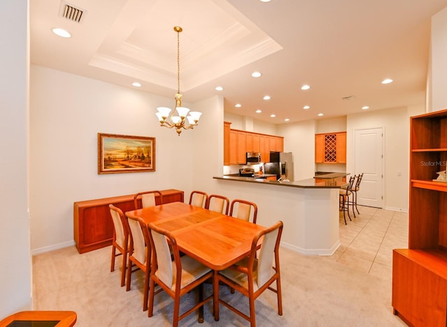 carpeted dining area with a raised ceiling