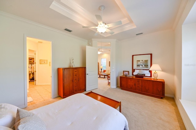 bedroom featuring light carpet, ornamental molding, a raised ceiling, and ceiling fan