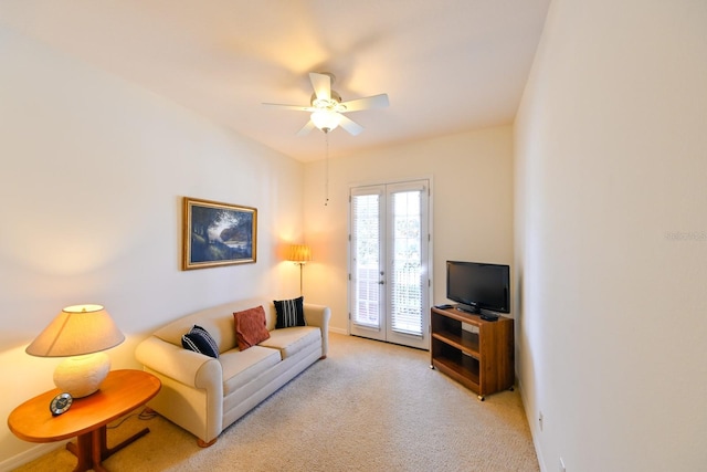 carpeted living room featuring ceiling fan and french doors