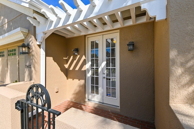 view of exterior entry featuring french doors